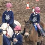 children riding ponies