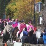 Everyone riding horses through the town for pink day