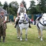 Three horse riders with their horses posing for photo