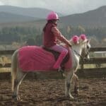 child riding pony