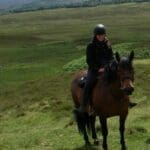 Riding horse through the mountains
