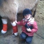 child on holiday, helping around with the horses