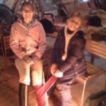 Family sitting nect to heater inside after a snow day
