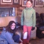 Children putting on christmas boots before heading out with horses